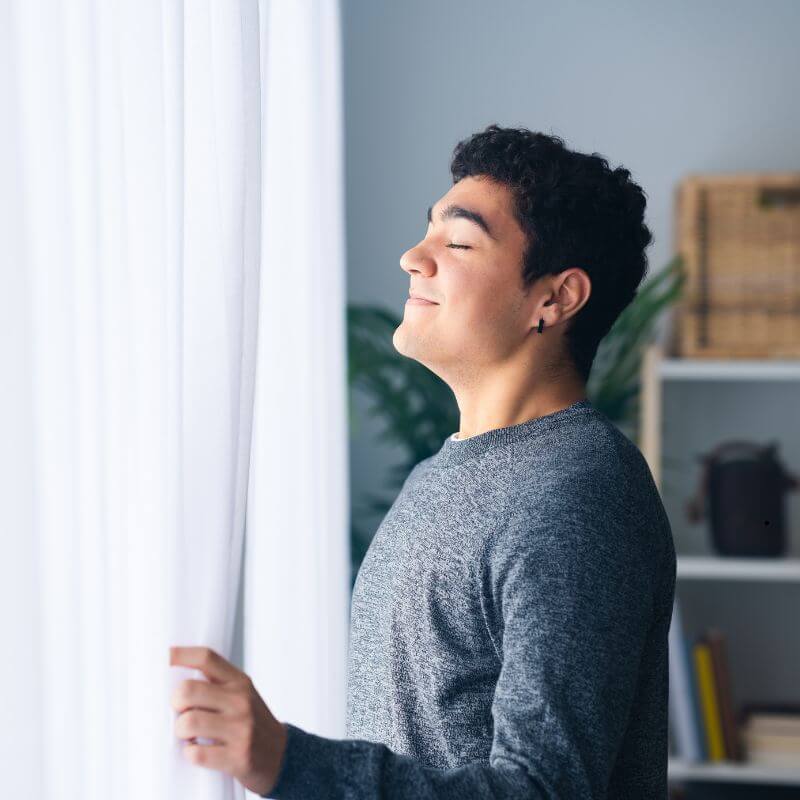 man breathing clean air indoors